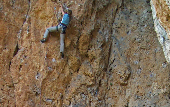Cathy rock climbing